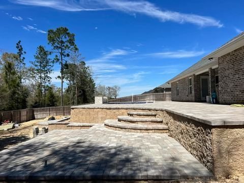Retaining wall and hardscape by Fénix Paver Landscape, 30A FL