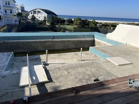 Travertine pool deck and pool pavers installed by Fénix Paver Landscape, 30A FL